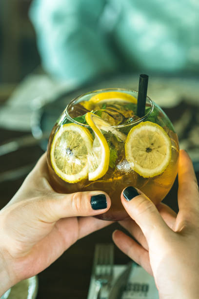 istock Woman hand holding iced cocktail 1267038050