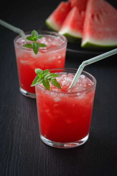 istock Summer cold drink with watermelon and mint on a black wooden background. 1267038143