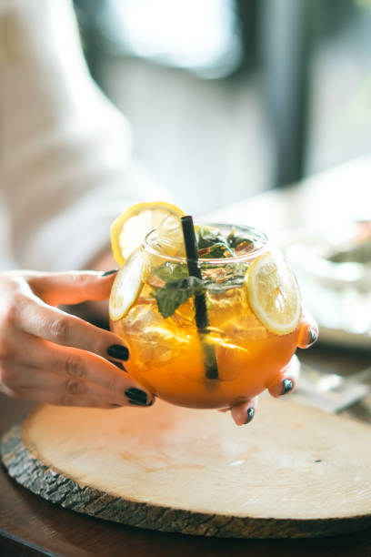 istock Woman hand holding iced cocktail 1267038234