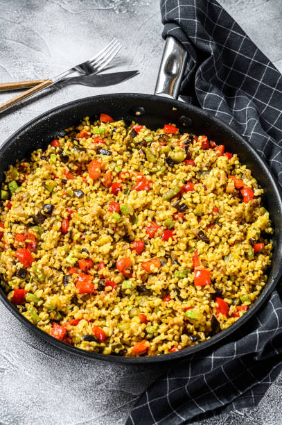 istock Cooked bulgur with vegetables and chicken meat in a pan. Gray background. Top view 1267039183