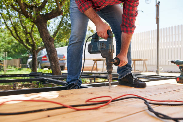 istock Carpenter screwing a screw with an electric drill 1267039841