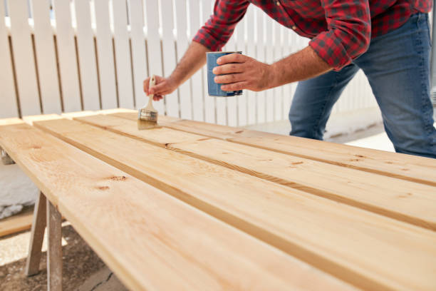 istock Unrecognizable carpenter lacquering wooden planks 1267039949