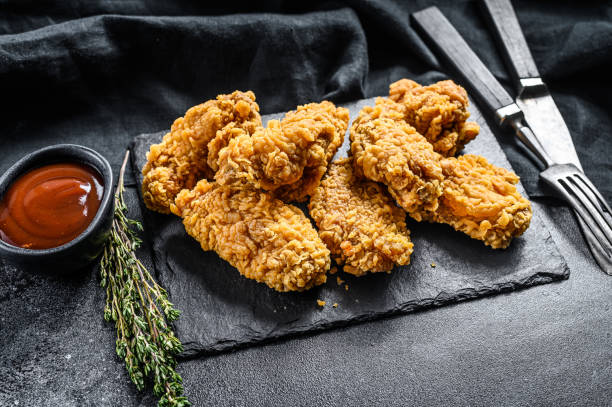 istock Spicy Deep Fried Breaded Chicken Wings. Black background. Top view 1267040049