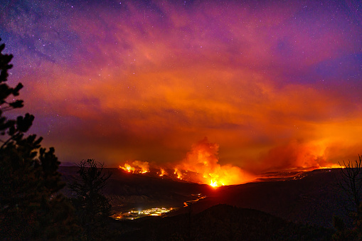 Milky Way Galaxy with Forest Fire Burning - Scenic landscape astrophotography with dark skies and fire burning from the Grizzly CReek Glenwood Canyon Fire. Dotsero, Colorado USA.