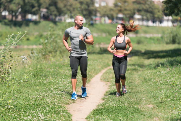 istock Young Couple Running Outdoors On A Lovely Day 1267042411