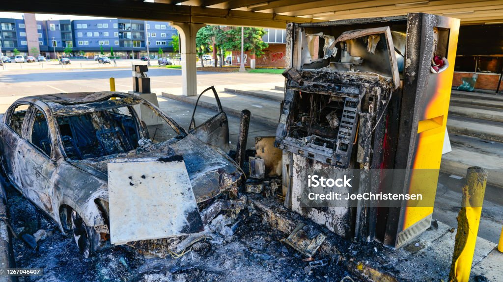 Car and ATM burnt in the City of Minneapolis after rioting and unrest Riot Stock Photo
