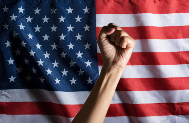 istock Hand with clenched a fist and U.S.A. flag. 1267047496
