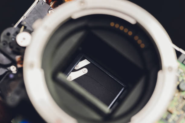 istock Engineer and technician Minitures are fixing camera mirror box assembly , Miniture workers are checking optics and carry out maintenance and cleaning of the broken camera at the service center. 1267047632