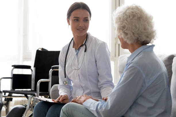 istock Young female doctor visiting disabled elderly mature patient. 1267049010