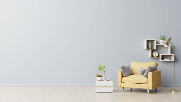 istock The interior has a yellow armchair on empty gray wall background. 1267052331