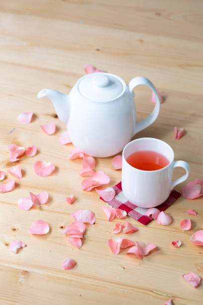Pink color Rose tea in white cup on wooden table
