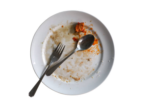 istock Dirty dish with spoon and fork isolated on background 1267062734
