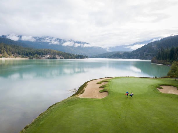 istock Two golfers make their way towards the green 1267063688
