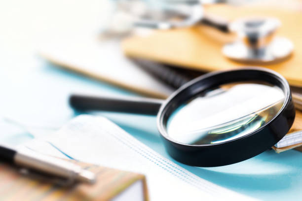 istock Doctor's workplace with magnifying glass stethoscope or phonendoscope notebooks and documents 1267071425