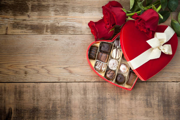 valentine's day box of chocolates and red roses - single flower bouquet flower holidays and celebrations imagens e fotografias de stock