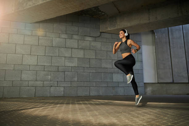 istock Positive delighted young female person jumping high 1267077395