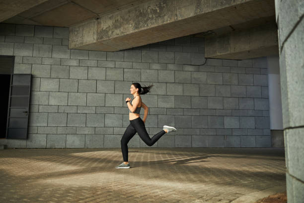 istock Active female person running quickly on the sidewalk 1267077404