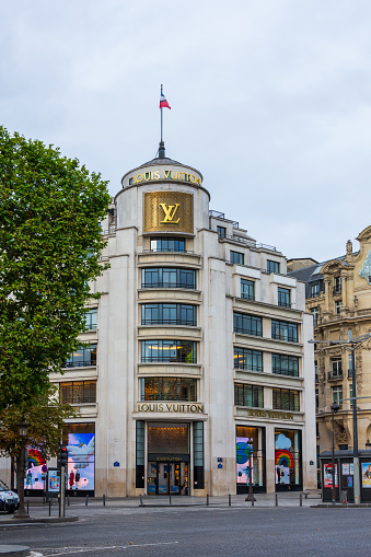 PARIS, FRANCE - AUGUST 15, 2020: Louis Vuitton building on the avenue des Champs-Elysées. Built in 1931, it is now the world largest retail store of the prestigious luxury brand