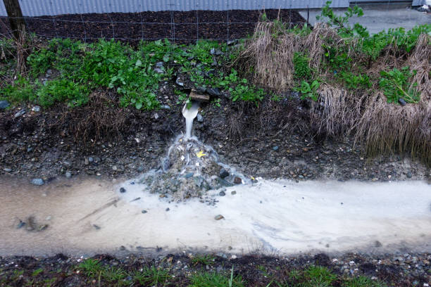 Polluted storm water run-off from an industrial site, Motueka, New Zealand. Polluted storm water run-off from an industrial site going straight into a drainage ditch, Motueka, New Zealand. motueka stock pictures, royalty-free photos & images