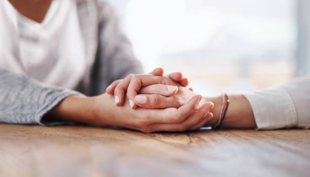 I'm going to help you get through this Closeup shot of two unrecognisable people holding hands in comfort emotional support stock pictures, royalty-free photos & images