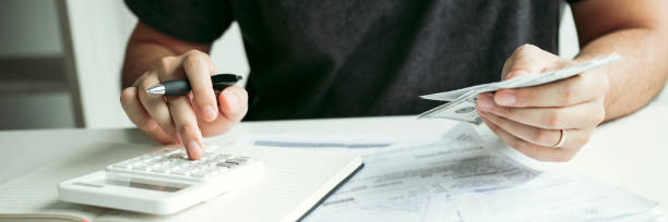 istock Man use calculators and documents that calculate expenses in the home office. 1267079203