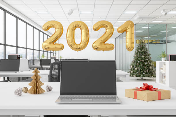 istock Laptop With Blank Screen In An Office Decorated With Christmas Tree 1267081182