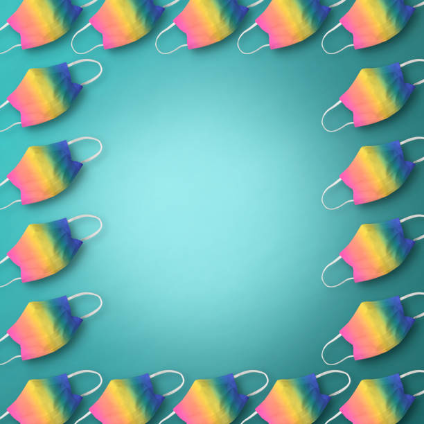 istock Frame of rainbow protective face masks in a row on light blue background. 1267084050