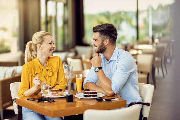istock Happy couple talking to each other while eating dessert in a cafe. 1267084776