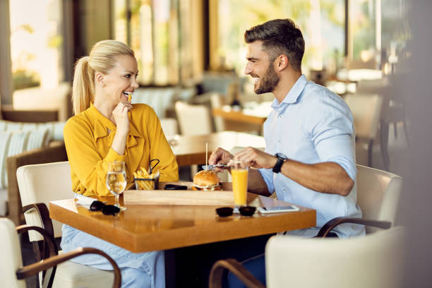istock Happy couple talking while having lunch in a restaurant. 1267085987