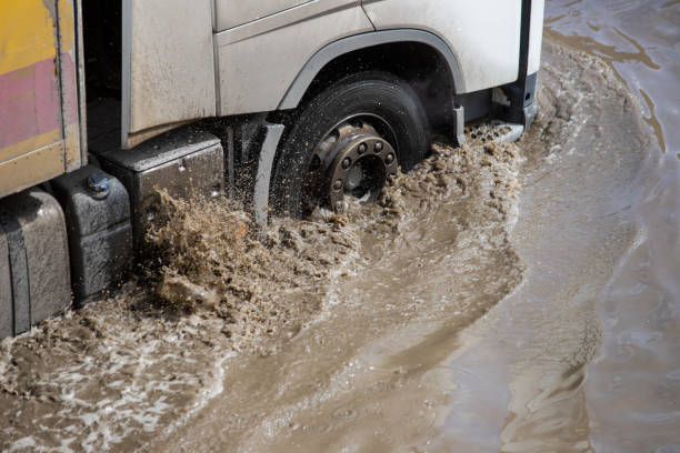 istock Car rides in heavy rain on a flooded road 1267086092