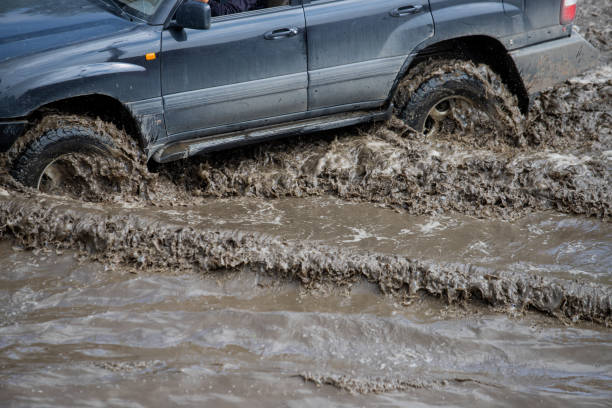 istock Car rides in heavy rain on a flooded road 1267086116
