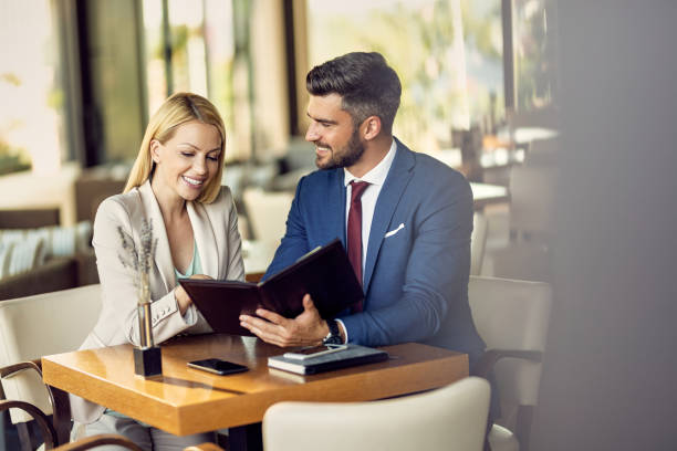 istock Happy business colleagues reading menu in a restaurant. 1267086124