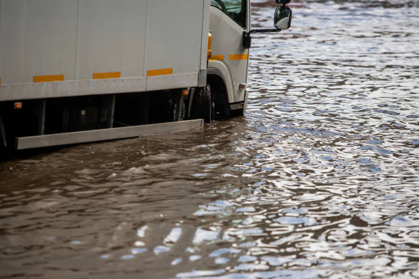 istock Car rides in heavy rain on a flooded road 1267086126