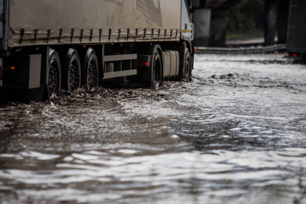 istock Car rides in heavy rain on a flooded road 1267086158