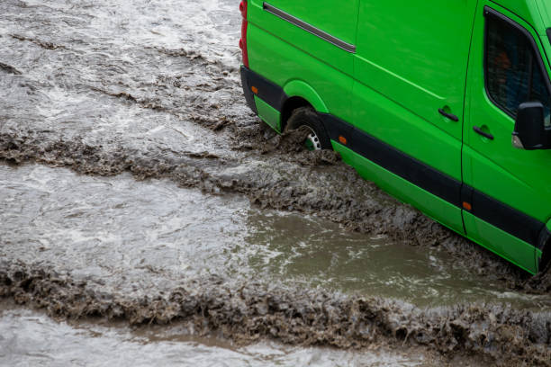 istock Car rides in heavy rain on a flooded road 1267086215