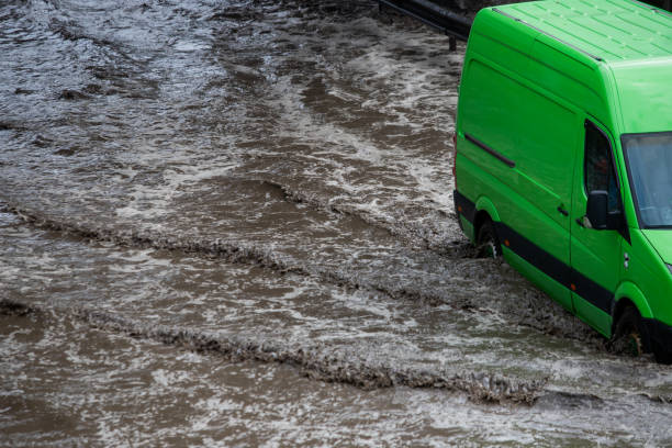 istock Car rides in heavy rain on a flooded road 1267086229