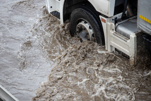 istock Car rides in heavy rain on a flooded road 1267086239