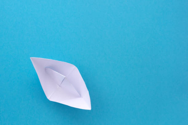 istock assembly procedure for a white paper ship. Origami. 1267089467