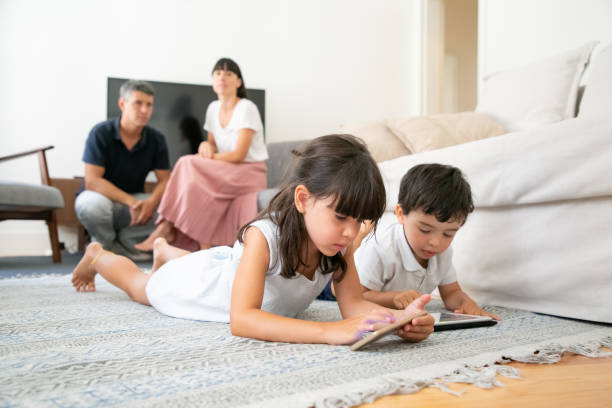 istock Cute little brother and sister using learning apps 1267090623