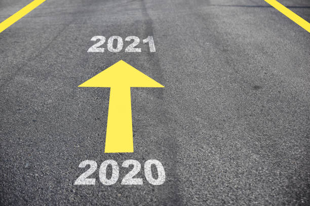 istock New year 2020 to 2021 on asphalt road surface with arrow 1267094898