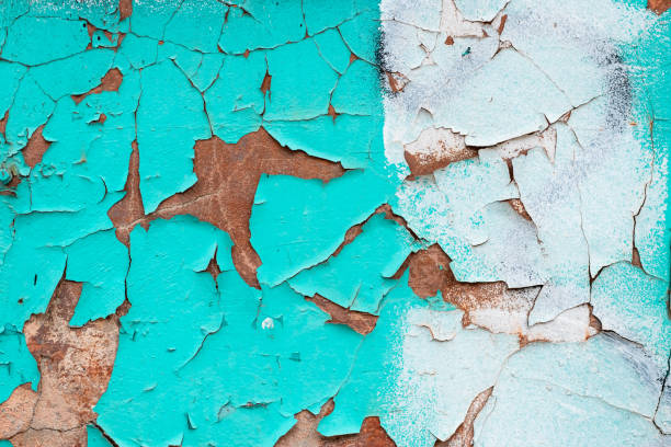 istock Peeling turquoise paint on a concrete wall. Blue and white painted abstract backgrounds, cracked rusty metal surface, faded texture, grunge wallpaper. 1267095269