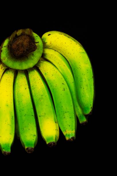 Closed up part of Green banana turning yellow ripe.