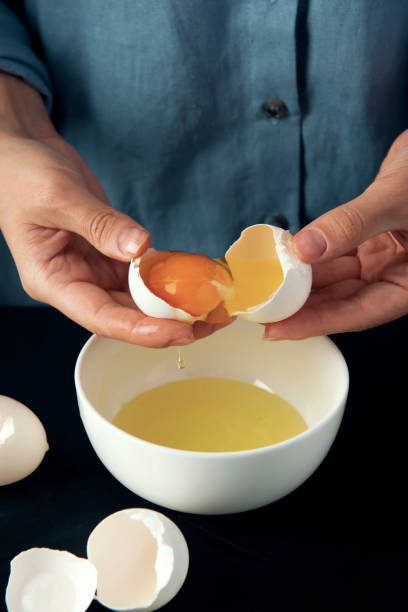 istock Woman breaks egg into the bowl. Cooking process. 1267096299