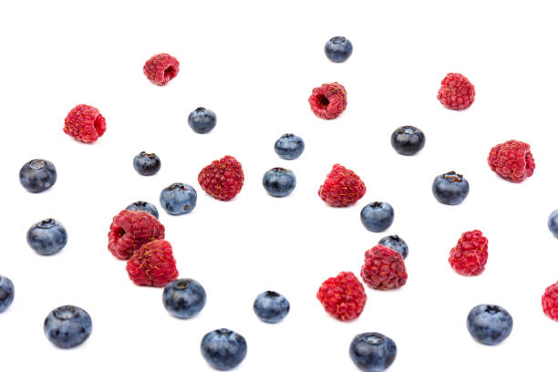 istock raspberries and blueberries isolated on white background 1267096529