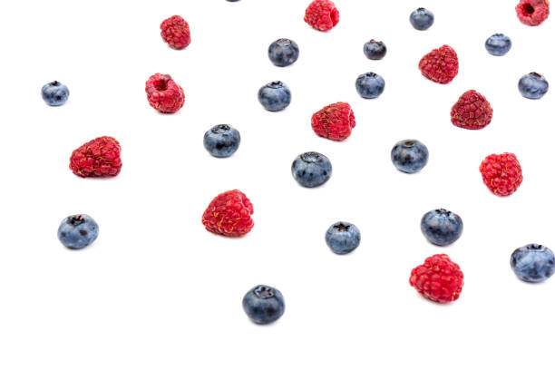 istock raspberries and blueberries isolated on white background 1267096544