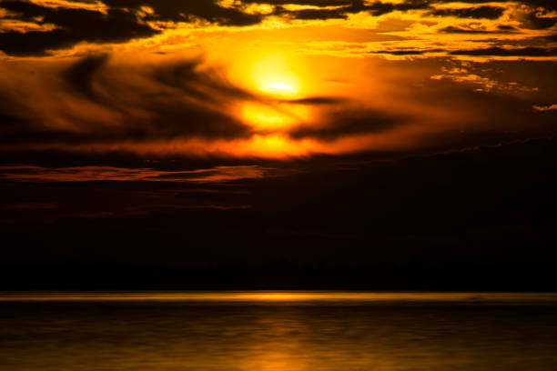 istock Sunset sky at the lake with rain cloud. 1267099120