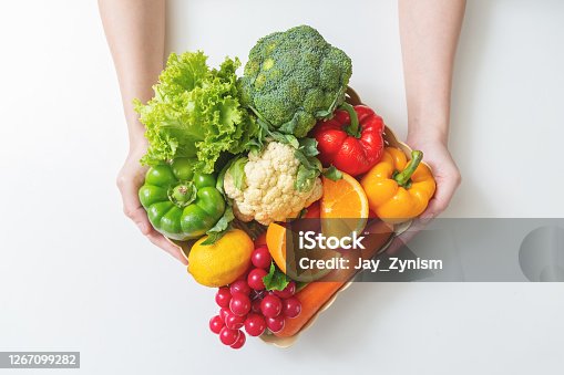 istock Closeup of  hands Woman with fresh vegetables in the box. top view 1267099282