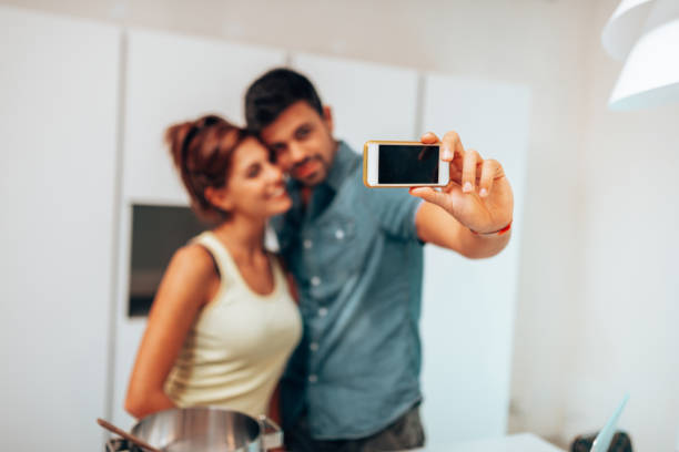 istock couple take a selfie at home 1267100149
