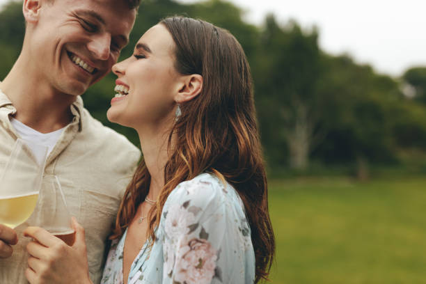 istock Affectionate couple with champagne at park 1267100168