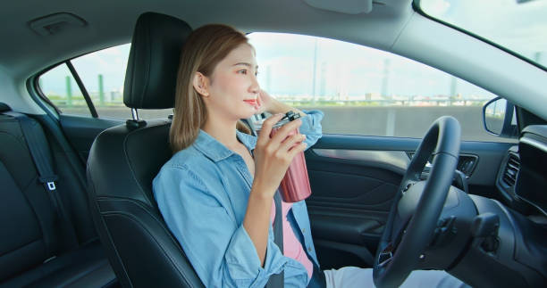 Smart self driving car concept relaxed asian woman experience to riding an autonomous self driving car and drinking on highway autopilot stock pictures, royalty-free photos & images